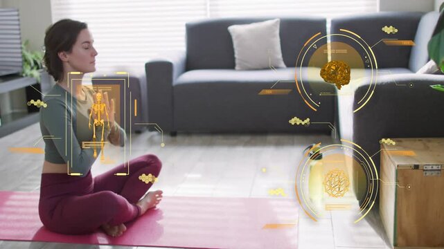 Woman breathing on pink mat, raising hands into prayer for wellness, AR overlaying skeleton, brain