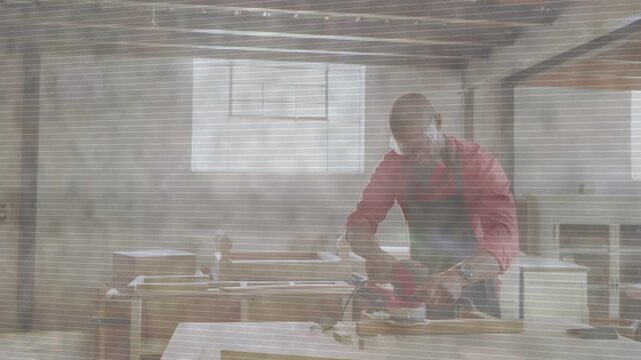 Male craftsman planing plank at workbench, checking grain then grabbing sander, smoothing wood