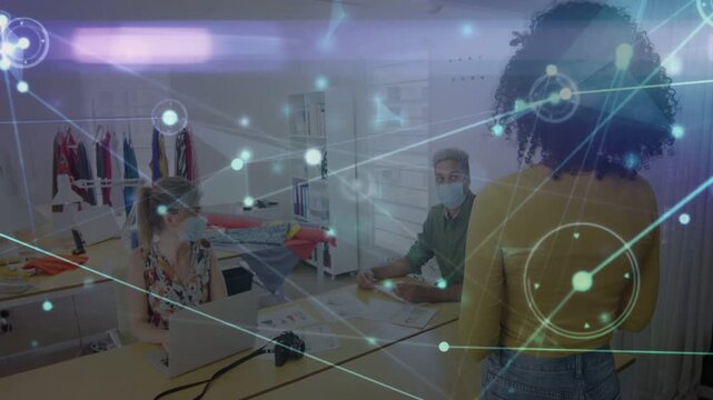 Standing presenter starting design review, animated network overlay linking laptop, garments, DSLR