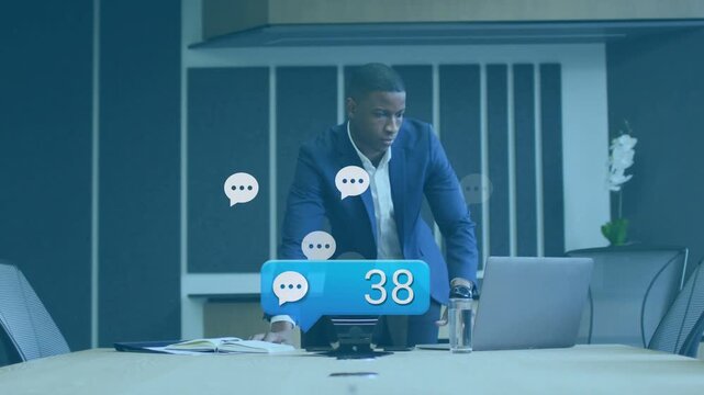 Business exec in room reacting to speakerphone as blue alert bubbles increasing, preparing response