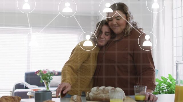 Women leaning at counter left woman reaching bread sparking social icons growing while showing love