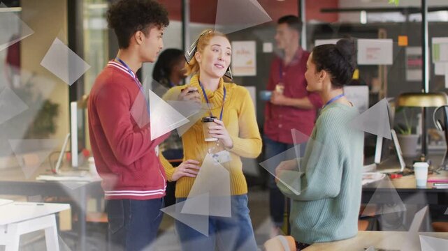 Team chatting near office on coffee break sipping cups while triangles obscuring subjects