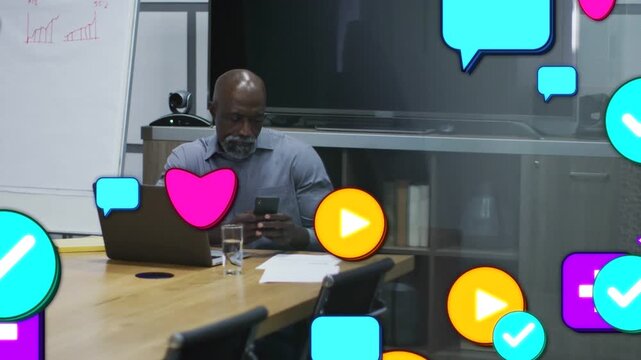 Manager checking smartphone at table, causing social media icons to multiply and obscure desk