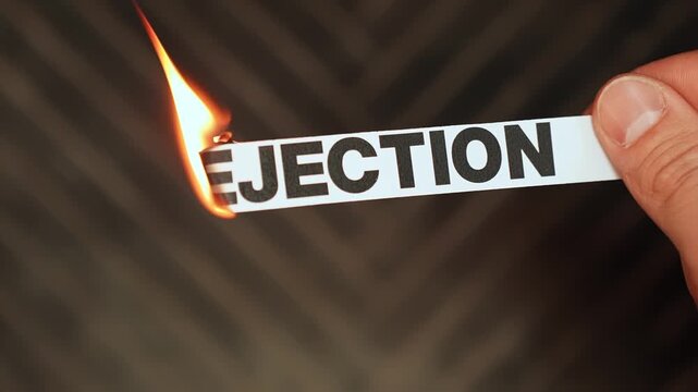 Burning &ldquo;rejection&rdquo; label held by hand, symbolizing acceptance, confidence, emotional resilience, and freedom from fear of exclusion, refusal, or social setback.