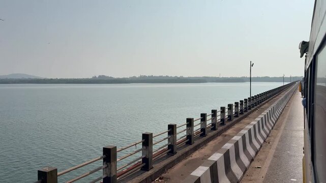 A bus crosses the majestic Kali River in Karwar in stunning 4K, with calm waters, scenic bridges, and lush greenery creating a perfect blend of travel and coastal beauty.