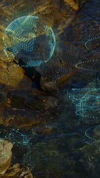 Vertical video: Holographic globe appearing over tide pools, rotating and mapping coastal networks