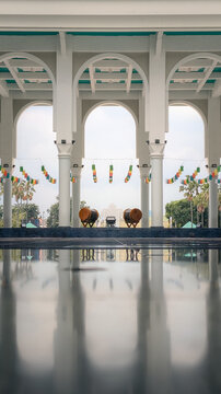 Modern mosque archway with reflective floor and traditional bedug drums