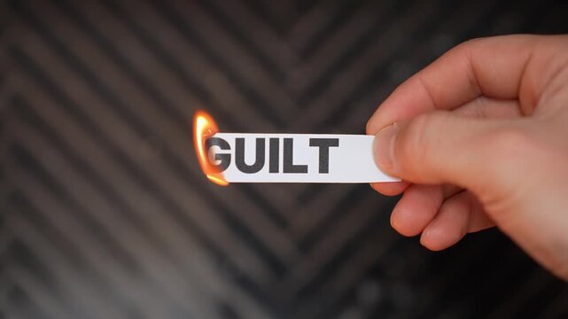 Burning &ldquo;GUILT&rdquo; concept symbolizing self-forgiveness, emotional healing, inner peace, and release from shame, regret, self-blame, and past mistakes.