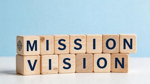 Business concept wooden blocks spelling Mission and Vision with a target logo on the first block corporate strategy planning blue background minimal workspace setup