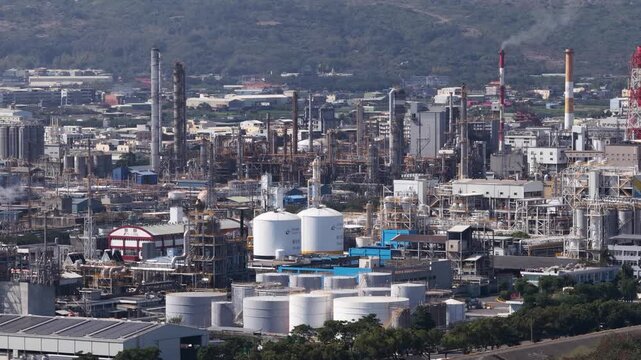 Aerial close up drone video of plastic manufacturing and chemical industry in Mueang Rayong District, Thailand, showing industrial production, petrochemical infrastructure, and factory operations.