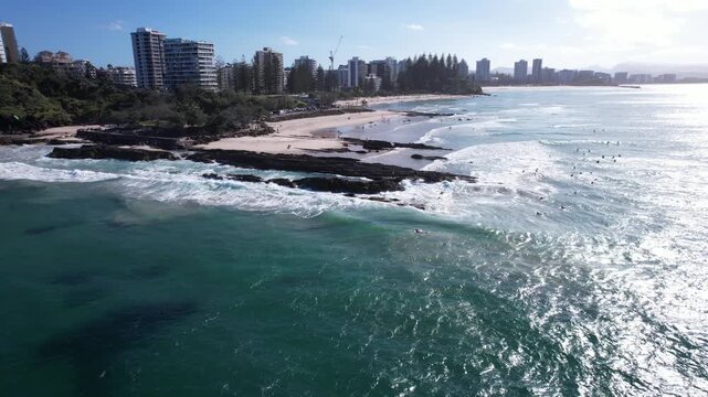 Surfers Near Rocky Outcrop Of Snapper Rocks In Coolangatta, Queensland, Australia. Aerial Drone Shot