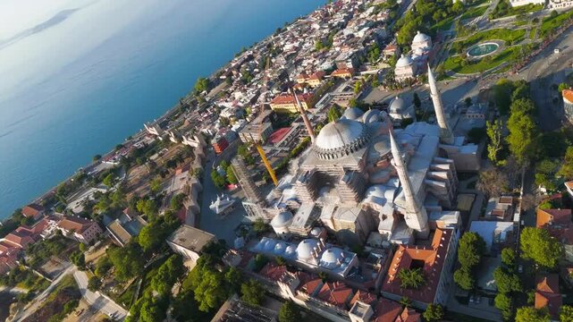 Istanbul, Turkey. Sunrise over Hagia Sophia Mosque in Fatih with golden morning light reflecting on sea. Aerial View, MasterShots, Fly Forward - Roll