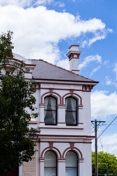 Curtained widows of old building on main street of Glen Innes