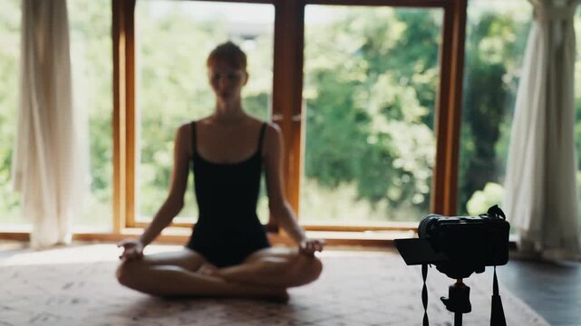 Yoga instructor recording online class at home studio