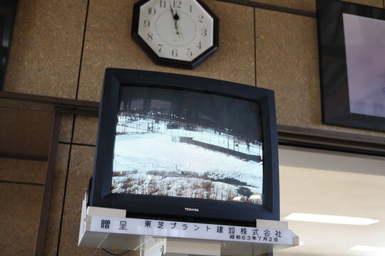 An old Toshiba CRT television shows a snowy field.
