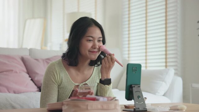 Asia people young gen z female happy smile enjoy phone apply selfie screen makeup blush virtual AI tech scan face app AR mixed augmented reality future beauty smart iot skin care help guide advice.