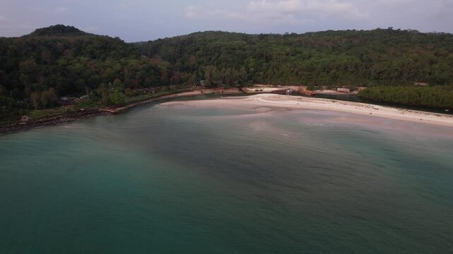 Coastline Of Khlong Chao Beach At The River Mouth At Sunset, Surrounded By Lush Vegetation In Koh Kood, Thailand. wide aerial shot
