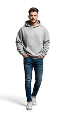 Naklejka premium A man in a gray hoodie and blue jeans walks towards the camera with his hands in his pockets on a white background