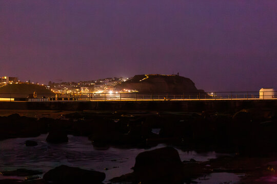 Merewether Ocean Baths coastal landscape at night looking towards Nobbys Head