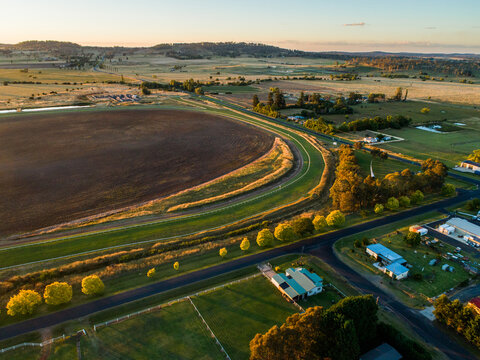 neat racetrack racecourse with tree lined road in rural landscape in NSW Australia