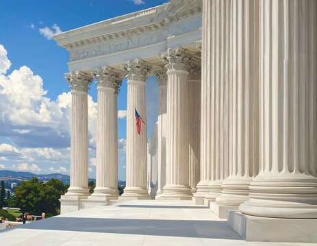 A white stone building with tall columns under a blue sky