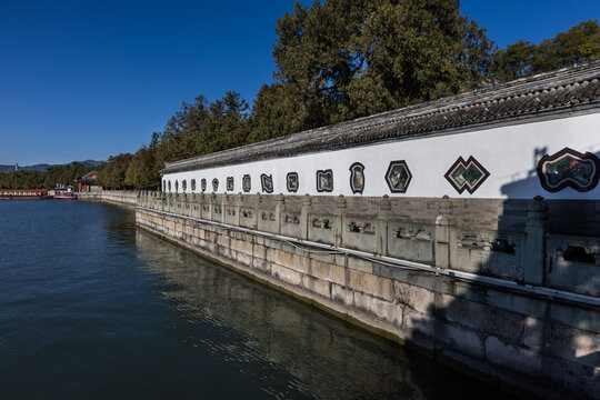 Corridor within Summer Palace next to Kunming lake in Beijing China, with windows in multiple shape being one of tourist attractions.