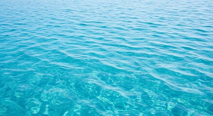 Obraz premium Glistening turquoise water shimmers with gentle ripples as sunlight dances across its surface