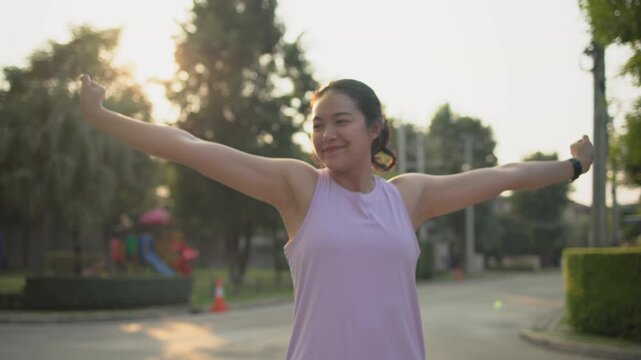 Asia young Gen Z people mindful happy woman open arm relax body deep stress relief outdoor nature green public park sun light self love anti aging life asian female mental health care modern medical.