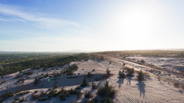 Explore less touristy white sand dunes in binh thuan vietnam at sunset with beautiful shadows and nature.