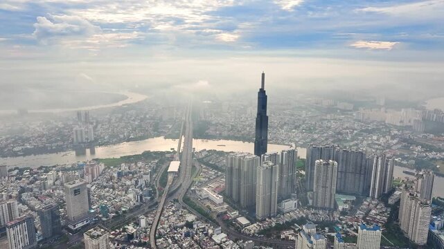 Drone shot of Landmark 81 and Saigon River, Ho Chi Minh City skyline in morning mist 