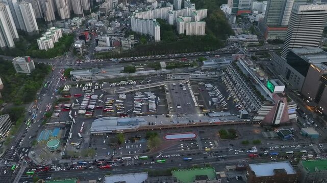 Aerial view of Seoul Express Bus Terminal at sunset with heavy traffic and city lights, Gangnam, South Korea.