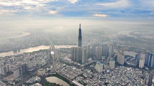 Drone shot of Landmark 81 and Saigon River, Ho Chi Minh City skyline in morning mist