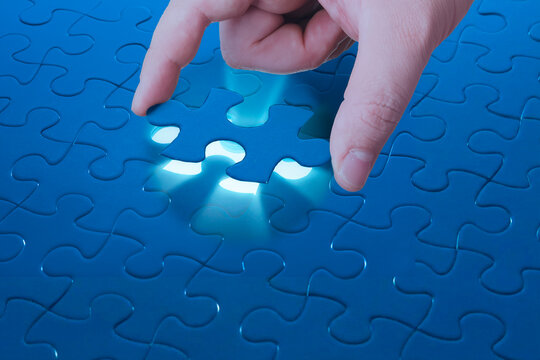 Missing jigsaw puzzle piece with light glow