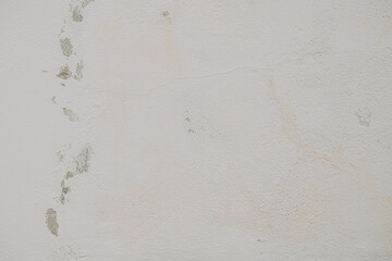 Fototapeta premium Closeup of a worn and weathered gray concrete wall with peeling paint