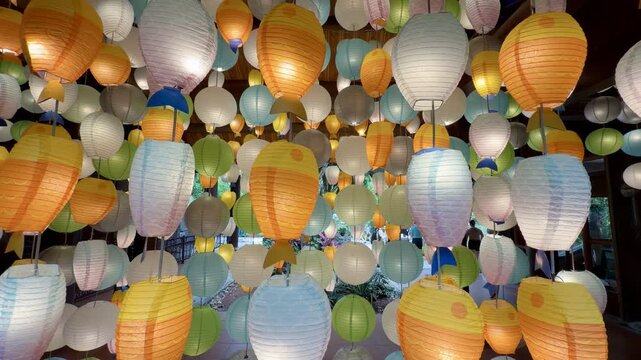 Hanging decorative paper lanterns shaped like colorful fish creating a festive atmosphere, ideal for celebrations and cultural events