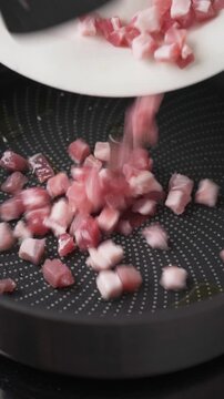 Adding diced pancetta to hot pan