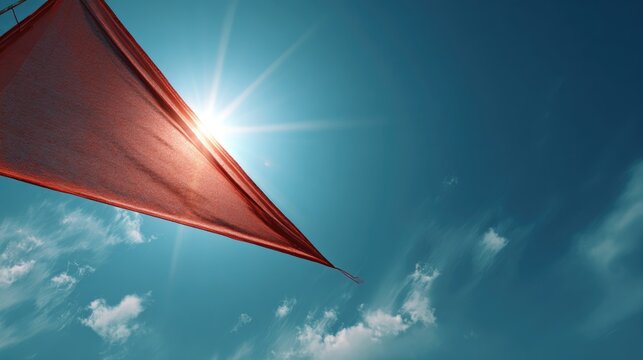 Commercial banner concept Nishan Sahib flag against a deep cerulean sky with light cloud wisps, sun behind the triangular flag creating a solar halo effect