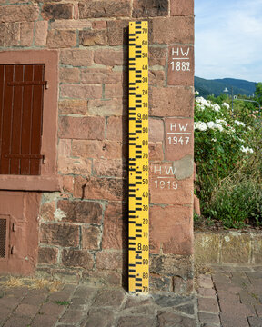 Water level gauge and flood marks on a old sandstone wall