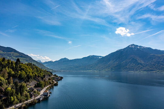 Aerial panorama of Lake Zug shoreline and alpine mountains near Arth - clear summer sky over Central Switzerland