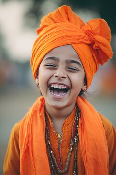 Sikh child wearing bright orange turban celebrating Vaisakhi, joyful laughter, shallow depth of field