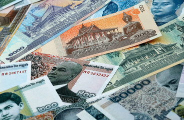 Cambodian riel money banknotes pile on table. Cambodia bills of KHR currency close up © Larysa