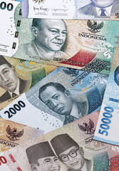 Indonesian rupiah money banknotes pile on table. Indonesia bills of IDR currency close up © Larysa