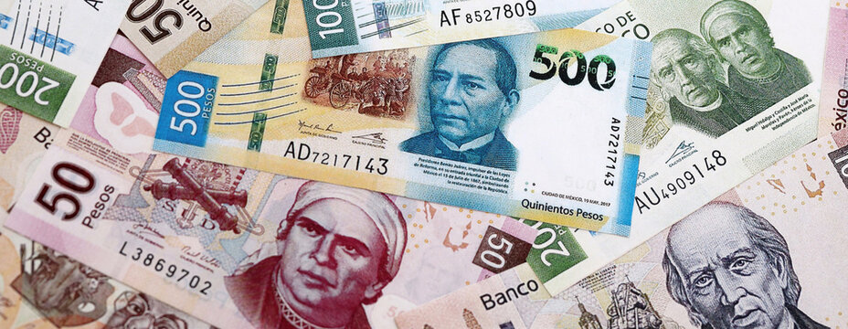 Mexican peso money banknotes pile on table. Mexico bills of MXN currency close up