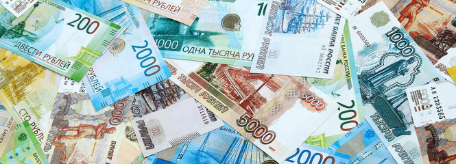 Fototapeta premium Russian ruble money banknotes pile on table. Russia bills of RUB currency close up