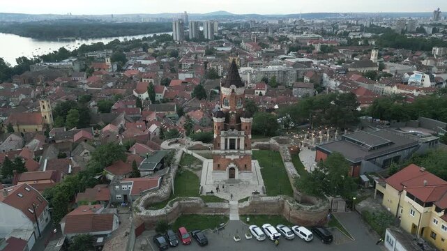 Drone flight pulling back from Gardos Tower overlooking the Zemun, Belgrade, Serbia. Panoramic view at dusk.