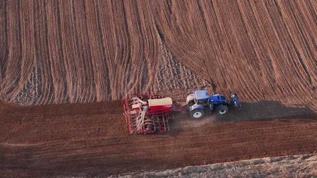 Tractor is harrowing the field