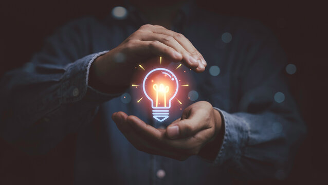 Creative idea innovation concept with glowing lightbulb in hands, symbolizing inspiration, problem solving, smart thinking and business creativity for generating solutions and driving success.