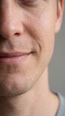 Obraz premium A close-up portrait of a man, with a subtle smile playing on his lips, hints at a depth of emotion and a sense of serenity.