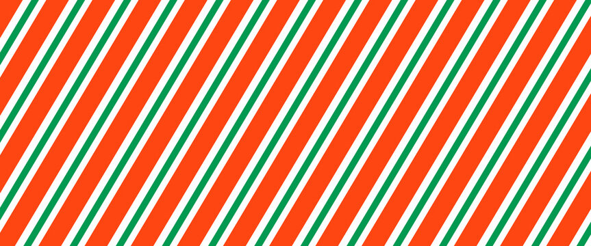 Christmas seamless pattern. Red and green diagonal stripes background. Candy cane repeating decoration wallpaper. Winter holiday lines backdrop. Xmas peppermint present wrapping print design. Vector