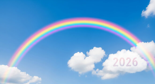 Bright blue sky with vivid rainbow arching across, white fluffy cloud with number 2026, future, positive outlook, hope, possibility